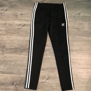 Black Adidas joggers with white stripes